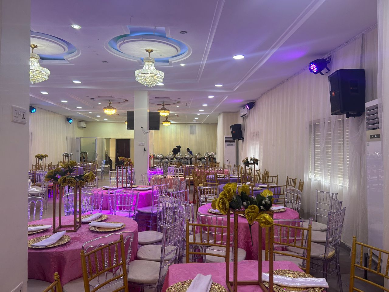 Wide view of Emerald Event Centre banquet hall set with chiavari chairs and chandeliers